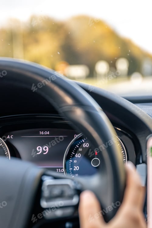 Preview: Steering wheel in a car close up, high speed driving on the road.