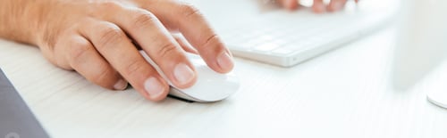 Preview: panoramic shot of broker using computer mouse near computer keyboard