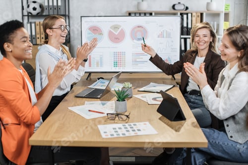 Preview: Multi ethnic female partners in formal clothes applauding together to their mature colleague