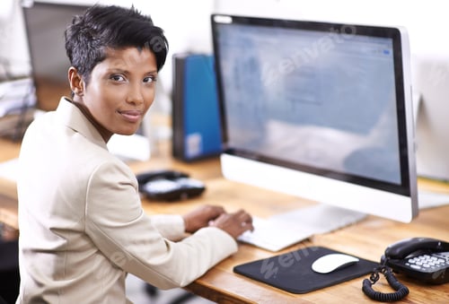 Preview: Shes a very diligent worker. Portrait of an attractive businesswoman working on a desktop computer.