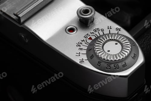 Preview: Depth of field scale and shutter release button of old film camera