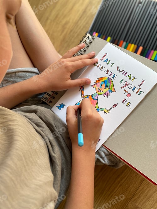 Preview: Caucasian boy drawing, makes postcard with motivation phrases- I’m what I create myself to be