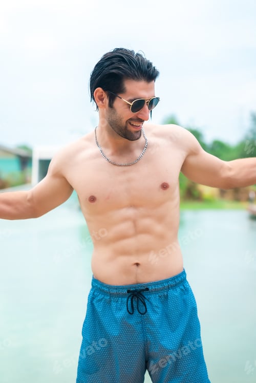 Preview: Sexy portrait of muscular handsome topless male model with perfect body in swimwear