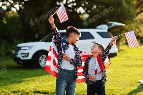Preview: Two brothers with USA flag. America holiday. Proud to be children of country.