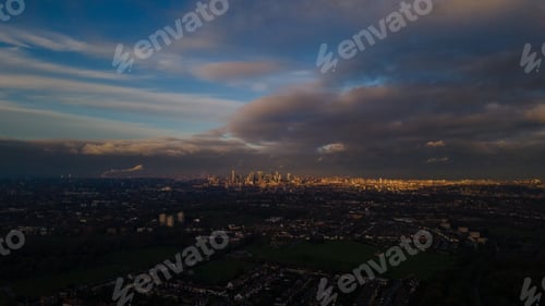 Preview: Aerial beautiful view of a cityscape under the cloudy sky at the sunset