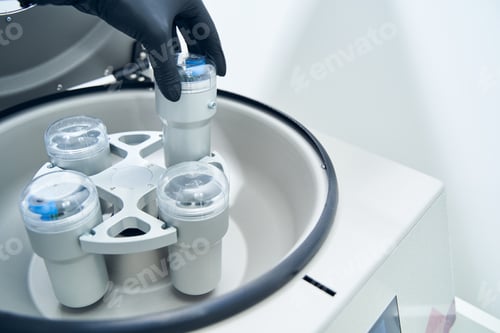 Preview: Researcher putting test tube into laboratory centrifuge