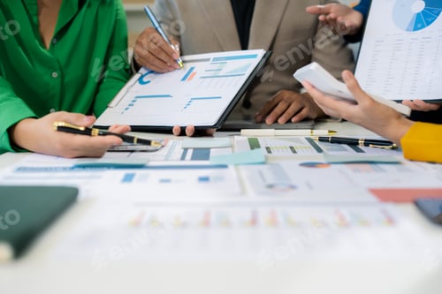 Preview: financial asian advisor showing plan of investment to clients in the consultancy office.