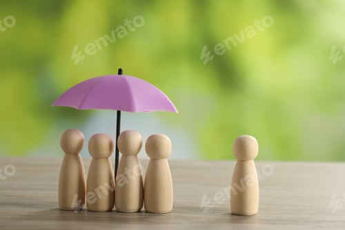 Preview: Human figures under umbrella and wooden one on table outdoors. Insurance concept