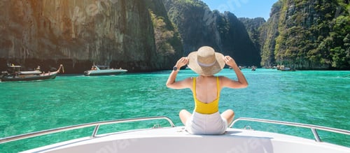 Preview: Woman tourist on boat trip, happy traveller relaxing at Pileh lagoon on Phi Phi island, Krabi