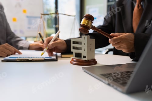 Preview: Real Estate Law in a courtroom the gavel, working with digital tablet computer.