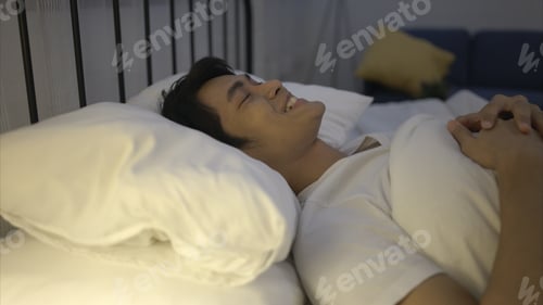 Preview: A young Asian man sleeps comfortably with a soft pillow.