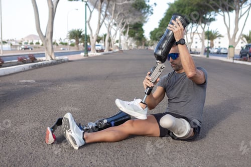 Preview: Sportsman changing leg prosthesis on road