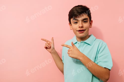 Preview: Young guy pointing aside in studio.