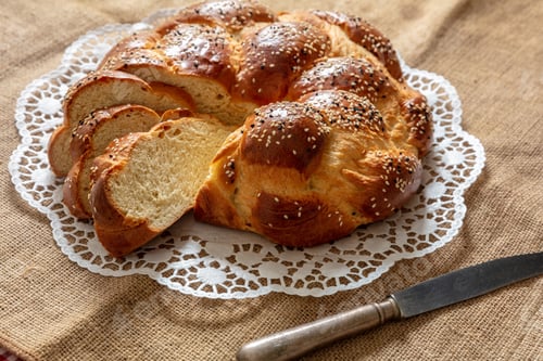 Preview: Easter sweet bread, greek tsoureki, brioche braid slice on table, close up view