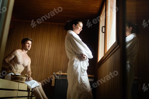 Preview: Couple enjoying finnish sauna during their spa weekend