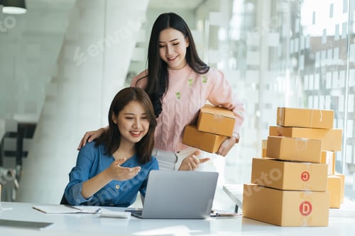 Preview: Two young Asian people startup small business entrepreneur SME distribution warehouse with parcel ma