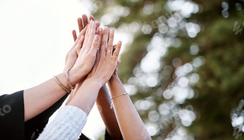 Preview: We did it. Closeup shot of a group of students giving each other a high five on graduation day.