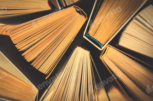 Preview: Old and used hardback books or text books seen from above.
