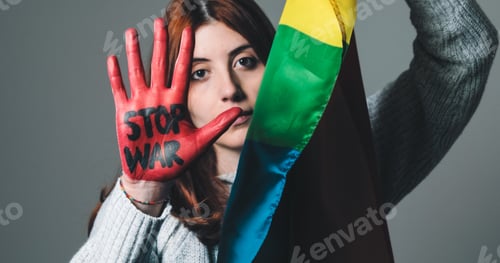 Preview: Girl wrapped in the peace flag raises her red hand that says stop war