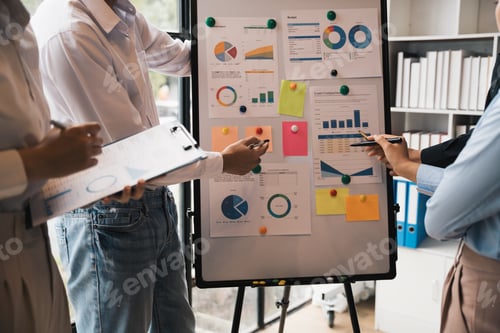 Preview: Business colleagues point and explaining to Monthly Budget, Financial and loan comparison on board,