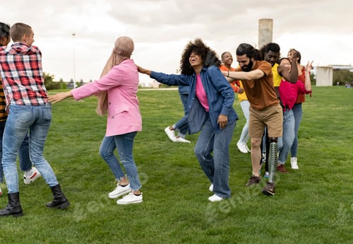 Preview: large group of diverse friends having fun together dancing in the park