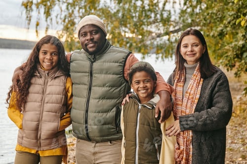 Preview: Young cheerful family of Caucasian mother, African father and two interracial kids