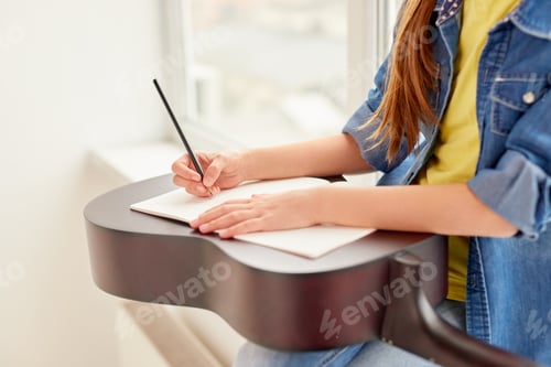 Preview: Crop girl making notes during guitar lesson
