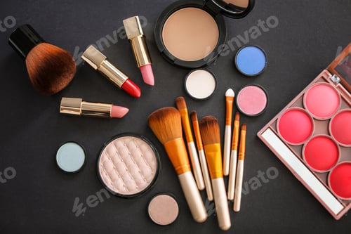 Preview: Flat lay composition with makeup brushes and cosmetic products on black background
