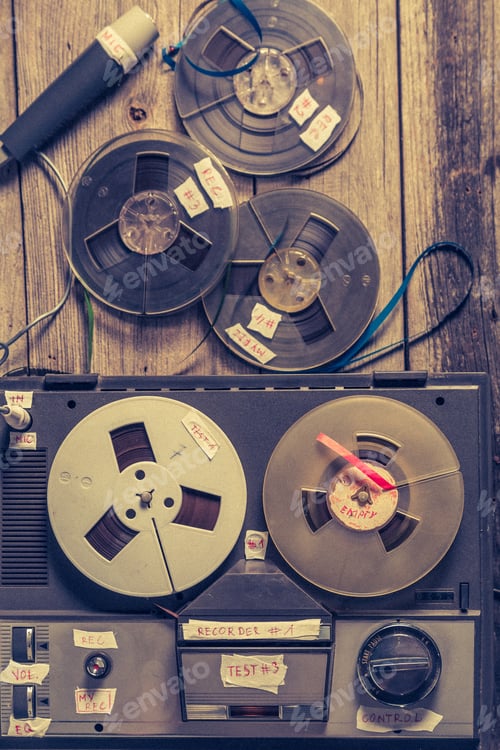 Preview: Retro reel-to-reel tape recorder and roll of tape and microphone.