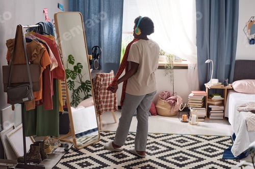 Preview: Woman choosing a new dress to wear