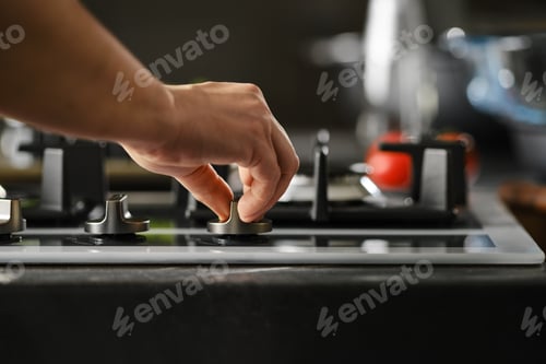 Preview: Hand switching on gas on a stove