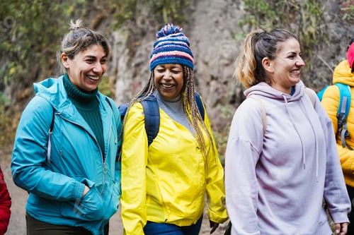 Preview: Multiracial women having fun during trekking day in mountain forest - Focus on african woman face