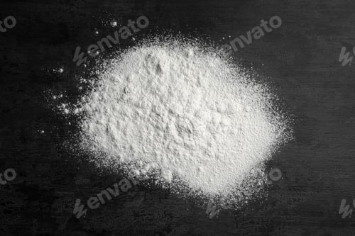 Preview: Scattered wheat flour on gray background, top view