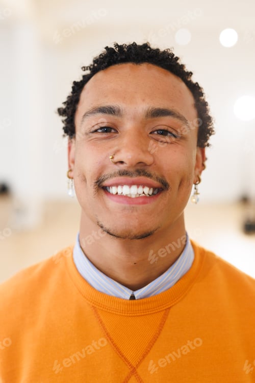 Preview: Vertical image of happy biracial male hip hop dancer posing to camera