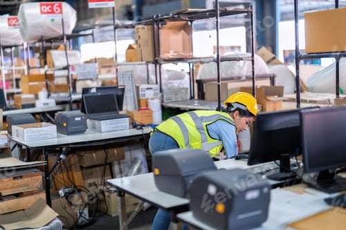 Preview: Worker working in the large depot storage warehouse happy smiling packing box at cashier counter