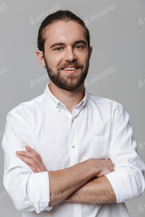 Man in White Shirt Smiling with Arms Crossed