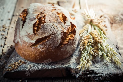 Preview: Homemade loaf of bread for breakfast on old wooden table