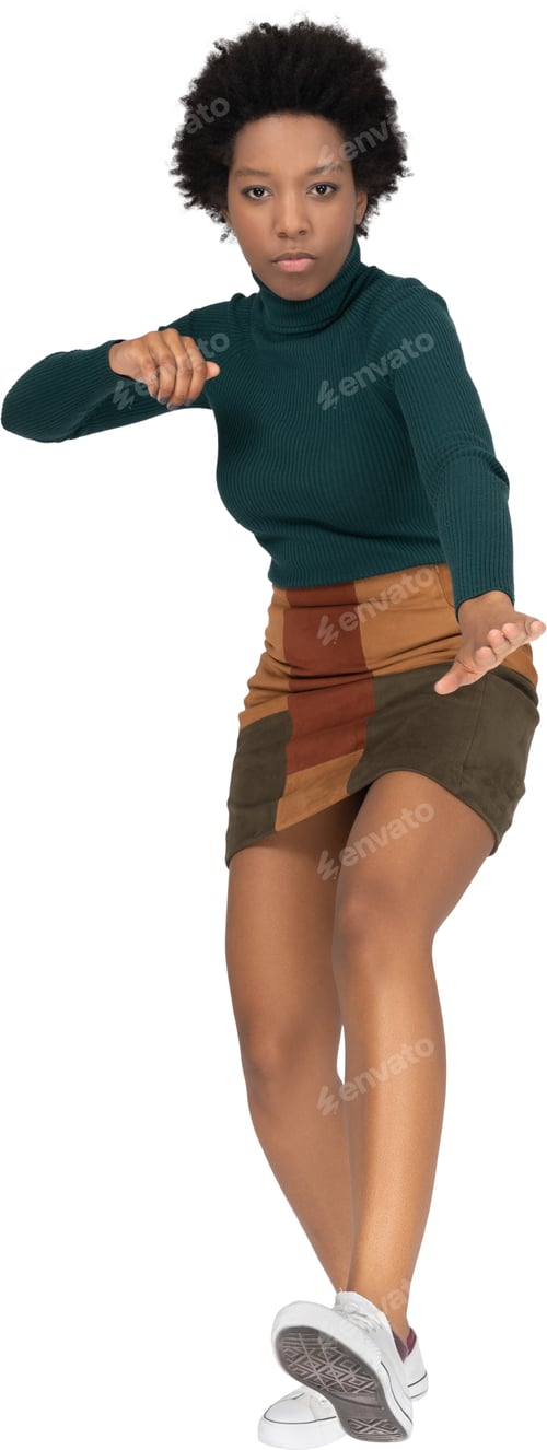 Preview: a woman in a green sweater and brown shorts