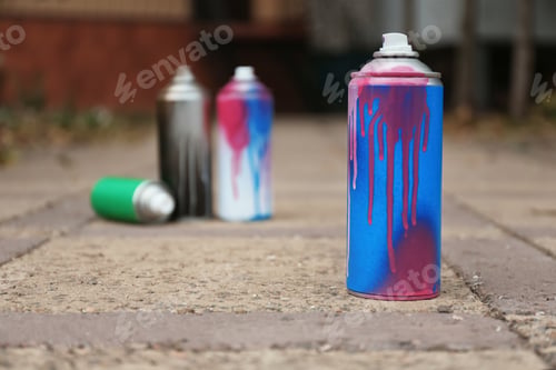 Preview: Used can of spray paint on city street. Space for text