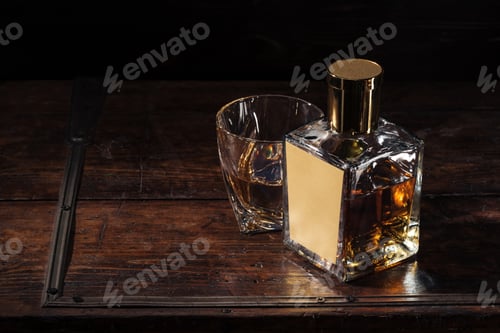 Preview: bottle with blank label and glass of whiskey on brown wooden table