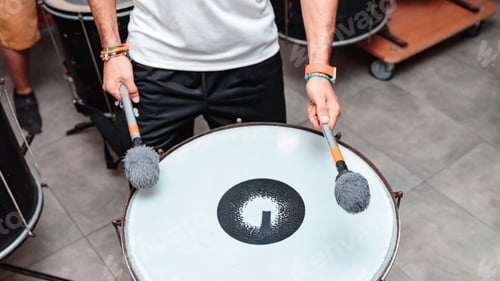 Preview: Hands of an unrecognizable person playing a drum with maces