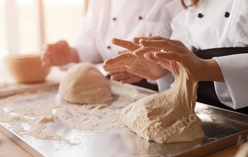 Preview: Crop kids kneading dough in bakery