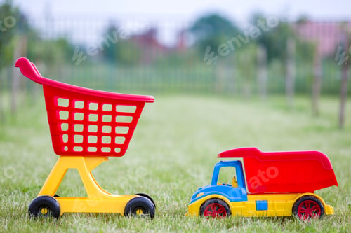 Preview: Bright plastic colorful toys for children outdoors on sunny summer day.