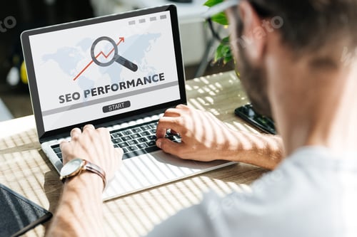 Preview: back view of developer using laptop with SEO performance and world map