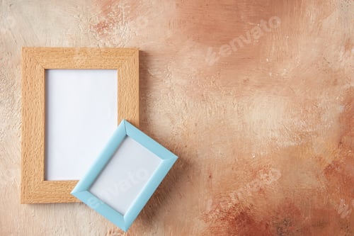 Preview: Top view of brown and blue photo frames on the right side hung on top of each other on mix color