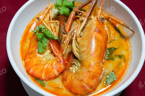 Preview: Top view closeup picture of famous Thai food called Tum Yum Kung. The big shrimp in the spicy soup.