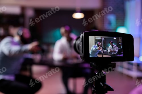 Preview: Content creator using camera to record podcast conversation