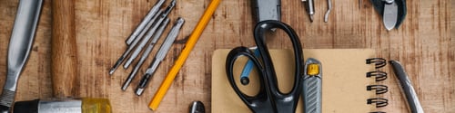 Preview: Tools and notebook lying on wooden table indoors