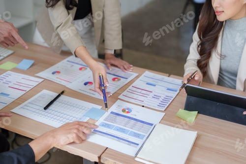 Preview: Business team analyzing financial data at meeting