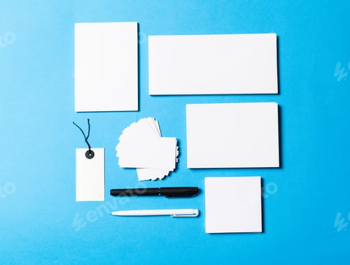 Preview: blank office objects organized for company presentation on blue paper background